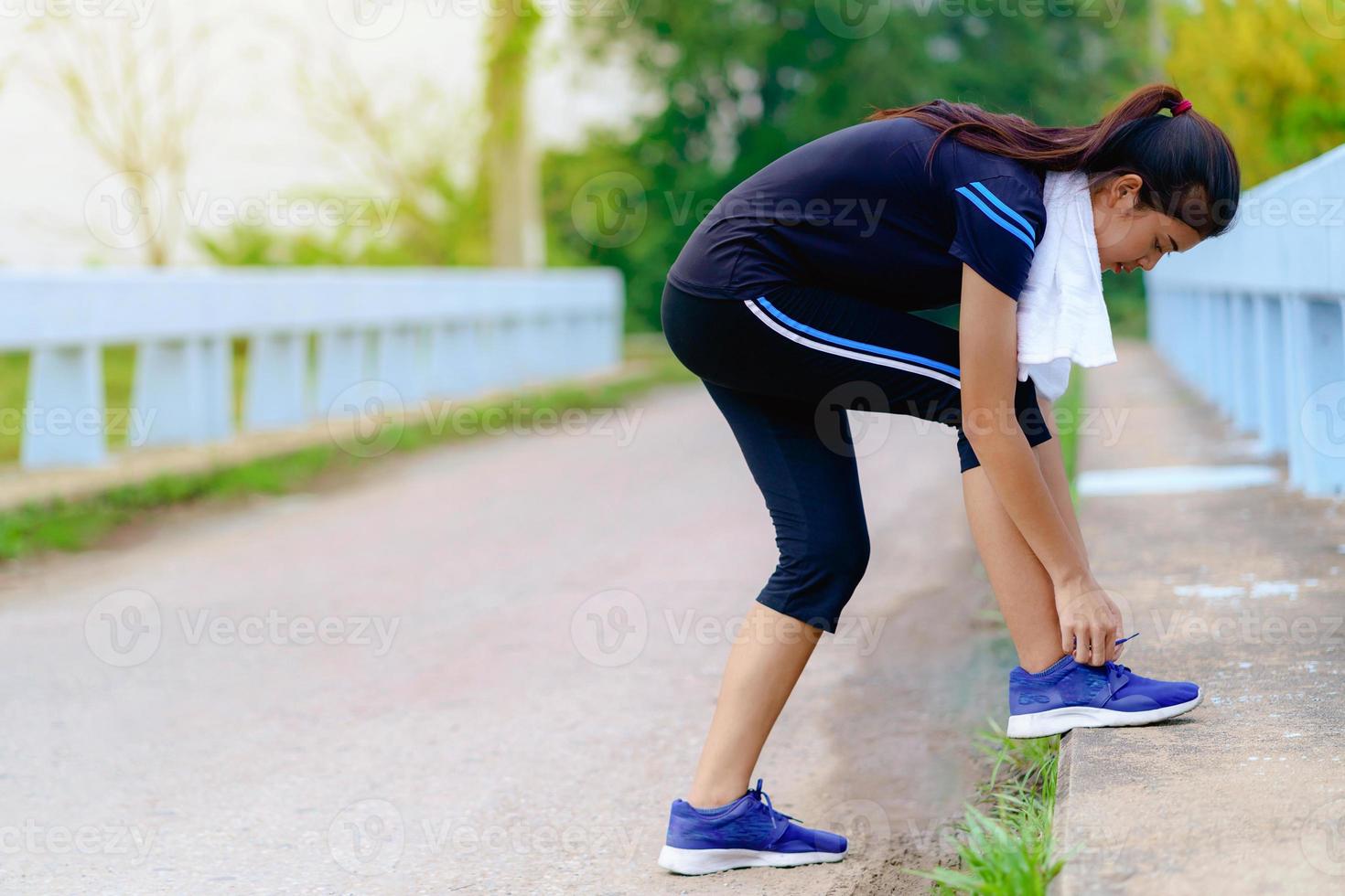 Girl runner trying running shoes getting ready for jogging photo