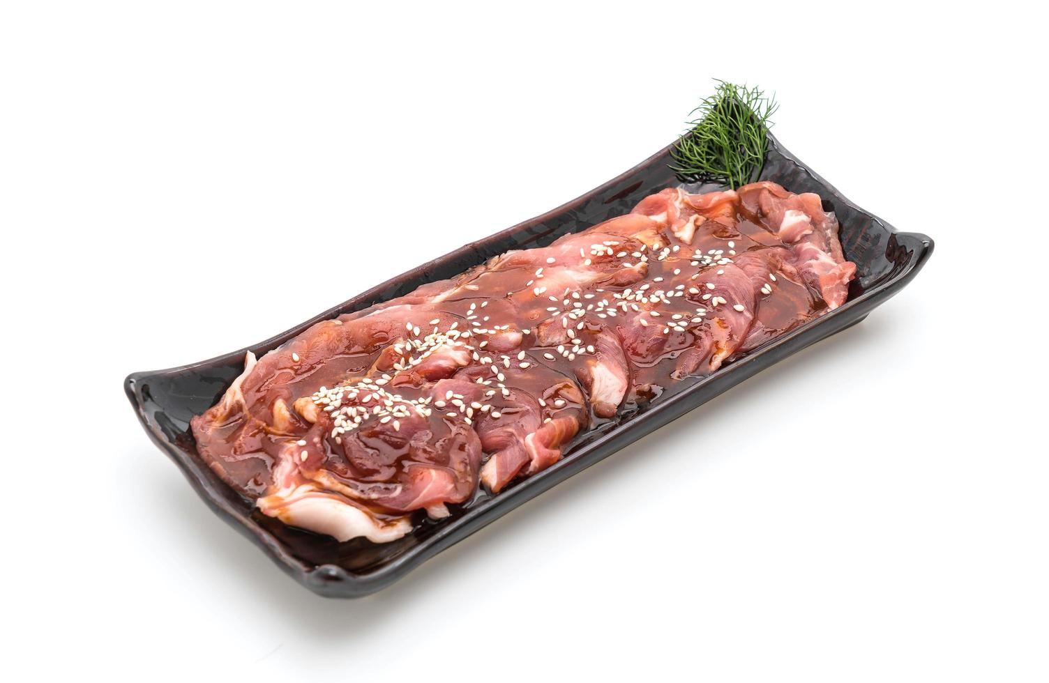 Fresh pork sliced with sauce and sesame on white background photo