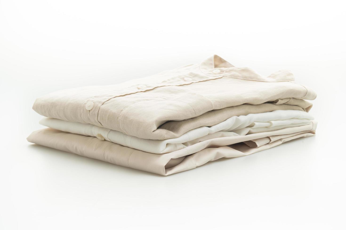 Beige shirts folded isolated on white background photo