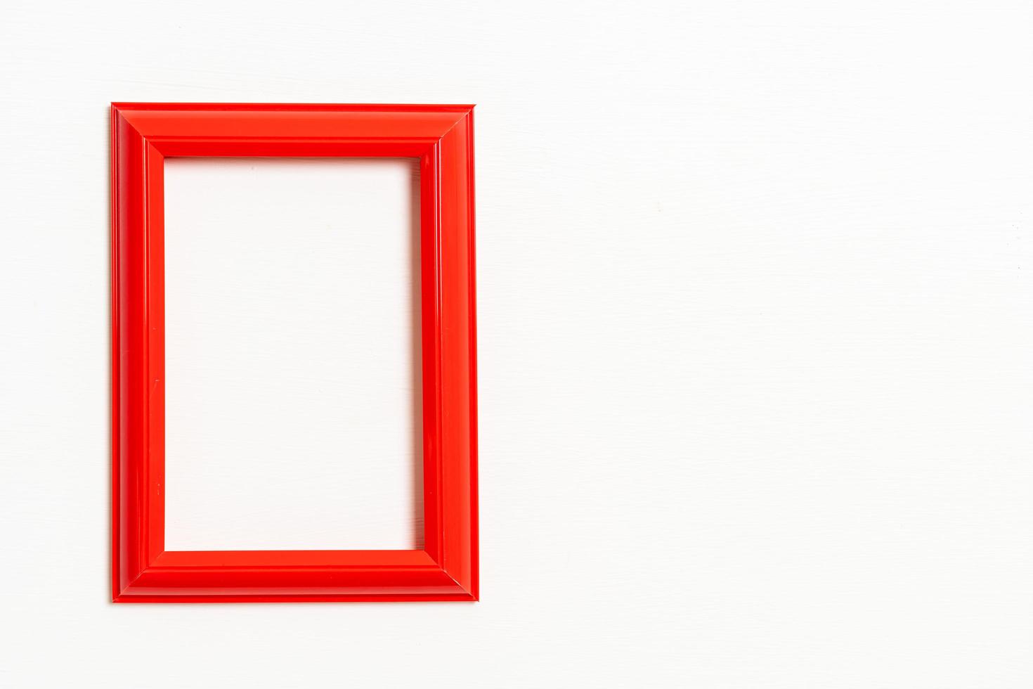 Empty picture frame on white wall background with copy space photo