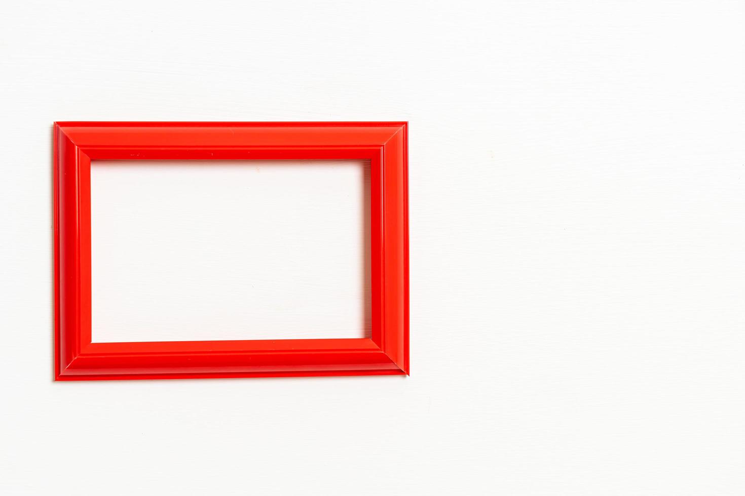 Empty picture frame on white wall background with copy space photo