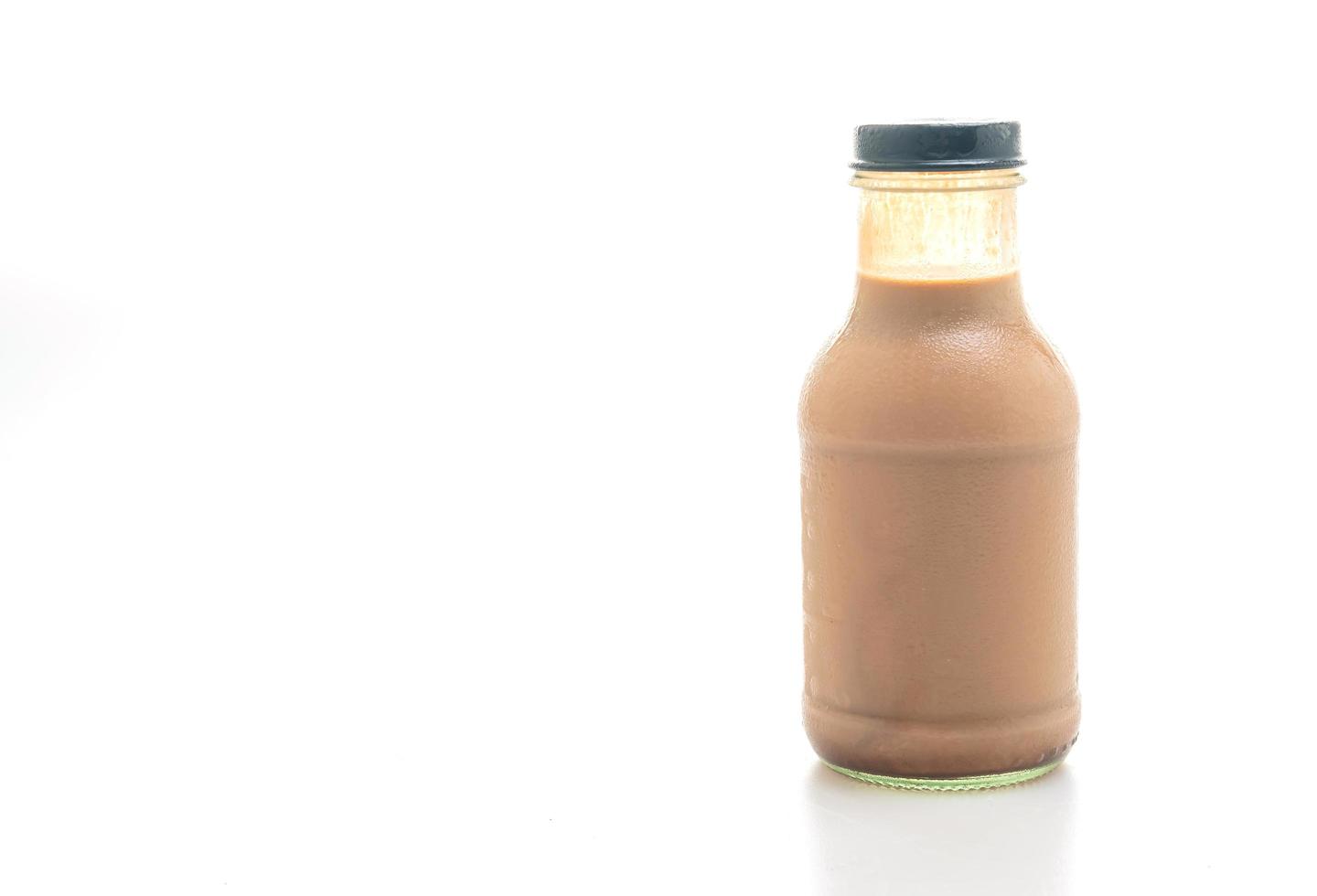 Chocolate milk in glass bottle on table photo