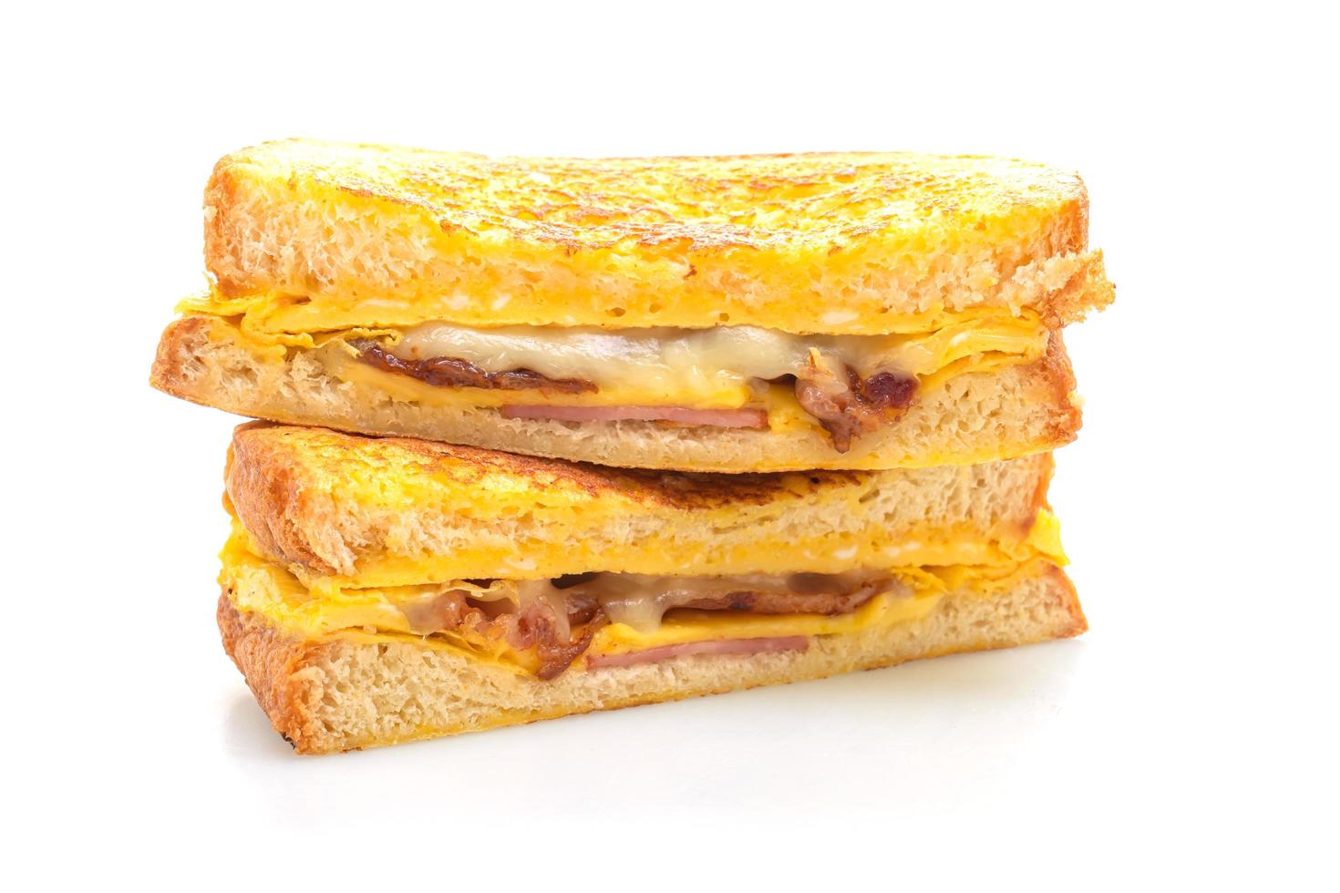 French toast ham, bacon, and cheese sandwich with egg isolated on white background photo