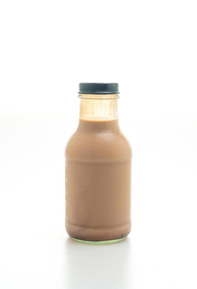 Chocolate milk in glass bottle on table photo