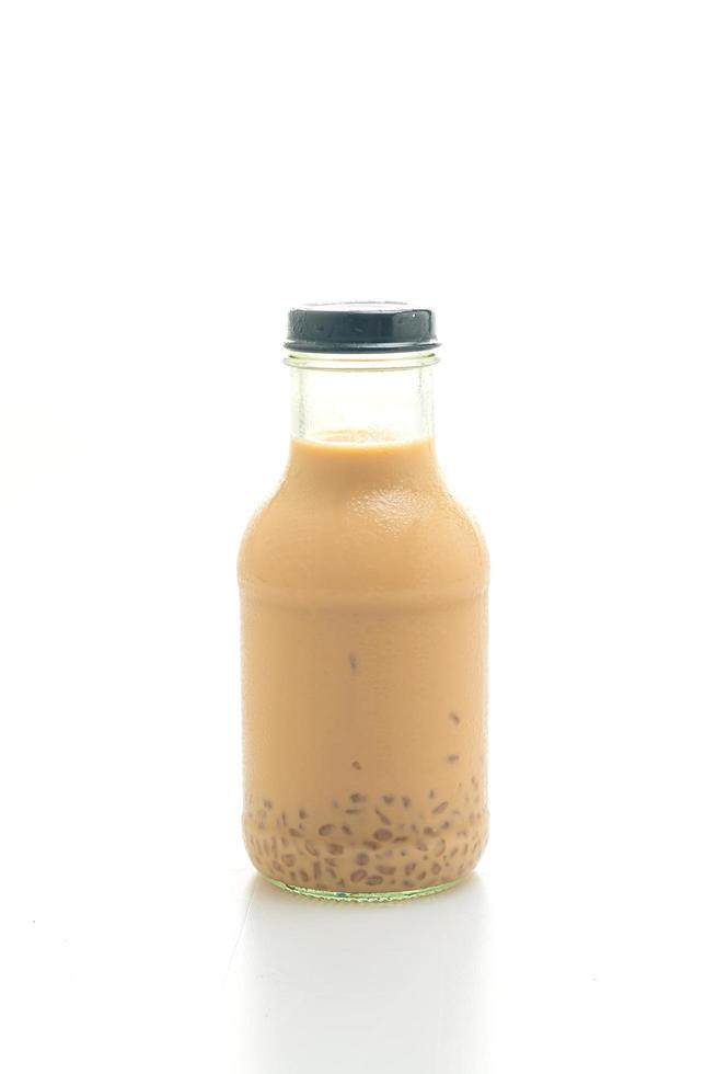 Milk tea with pudding jelly in glass bottle on the table photo