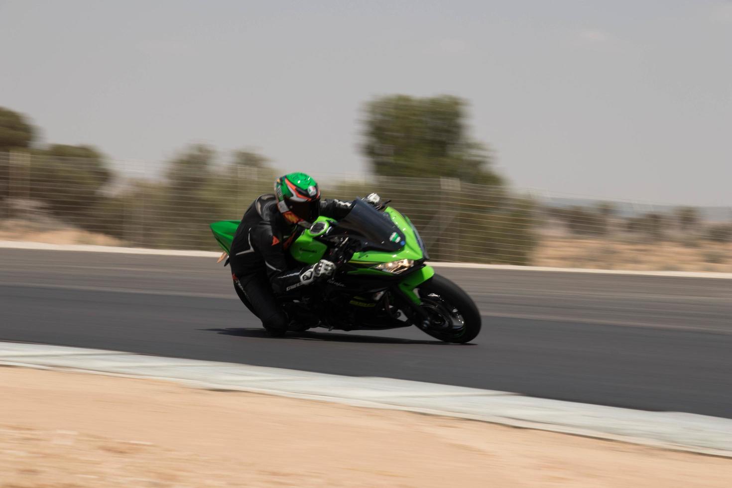 City, Country, MMM DD, YYYY - Motorcycle competition at a race track photo