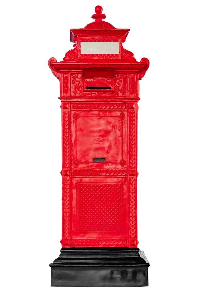 Isolated antique red post mail box on white background. photo