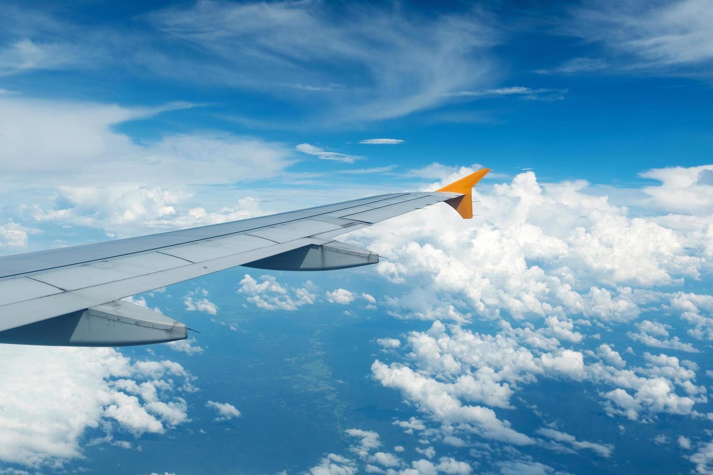 An airplane flying above the clouds. photo