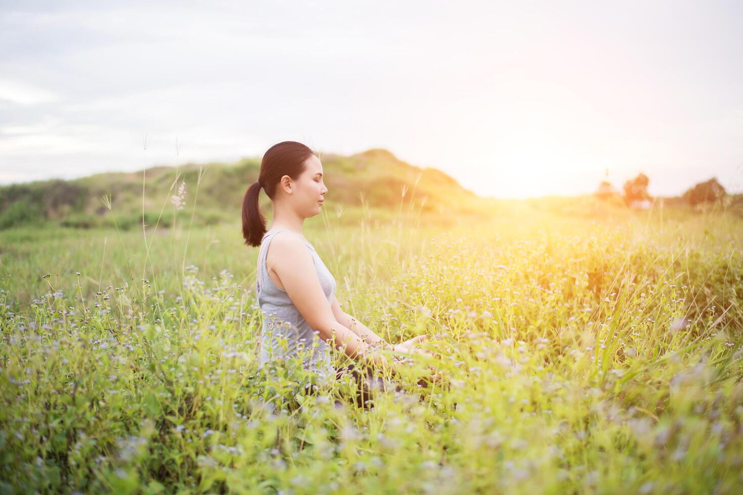 Beautiful woman in lotus position practicing yoga. photo