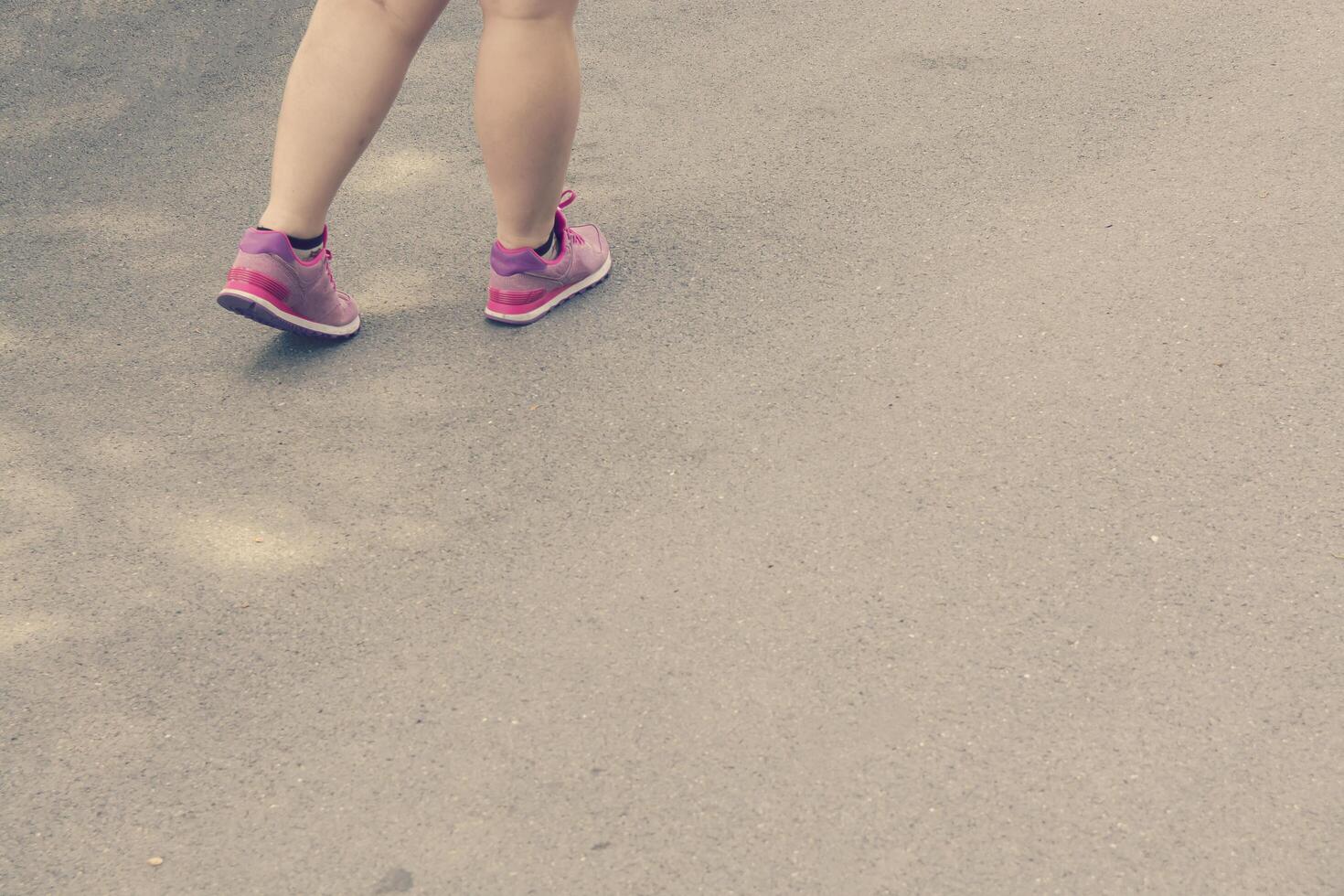 mujer gorda, piernas, ambulante, en, calzado deportivo foto