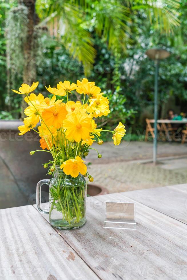 Yellow flowers decoration on dining table photo