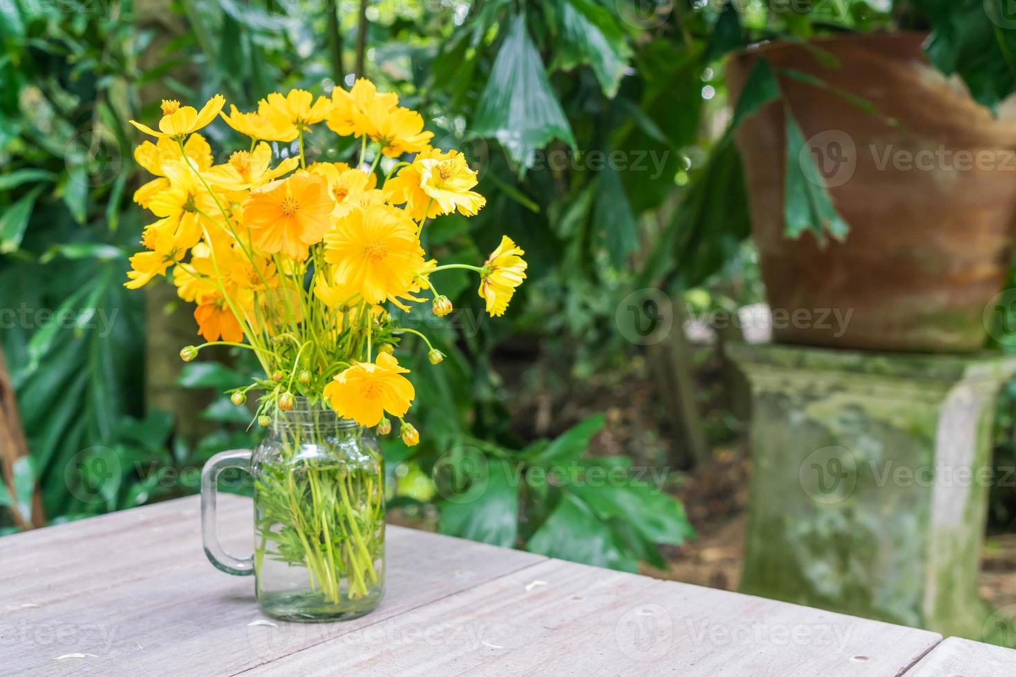 Yellow flowers decoration on dining table photo