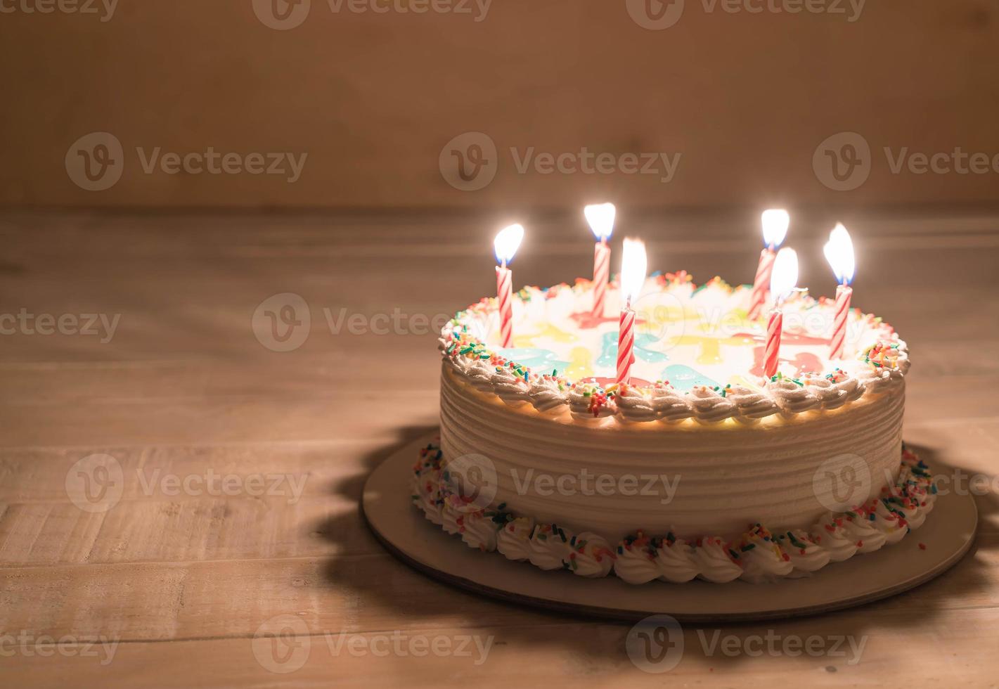 Happy birthday cake on table photo