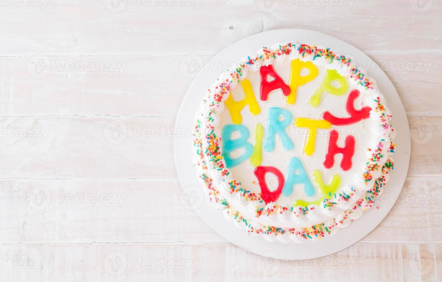 Happy birthday cake on table photo