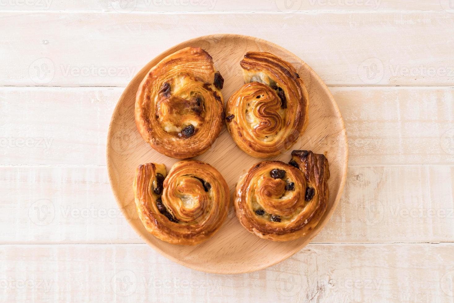 Cinnamon raisin roll on wood plate photo