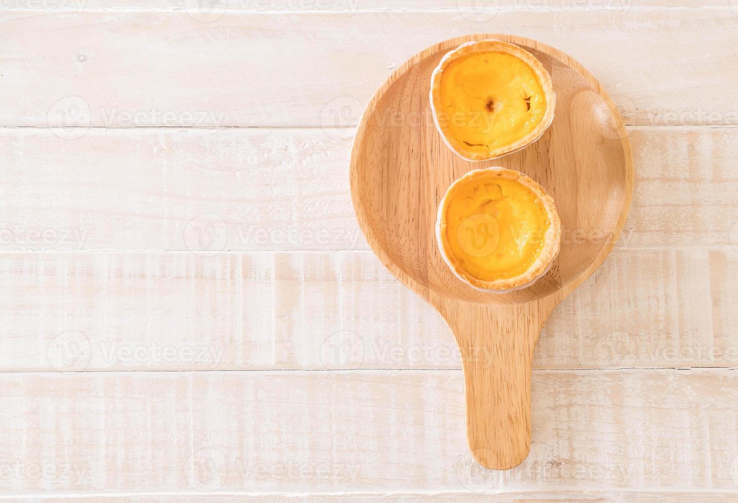 Egg tart on wood plate photo