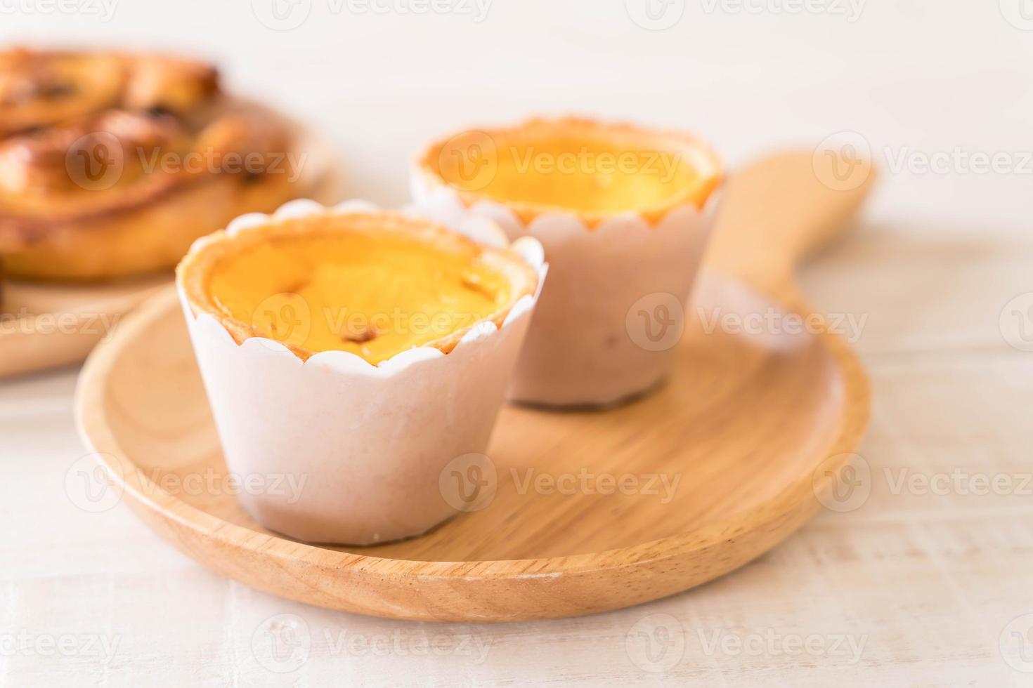 Egg tart on wood plate photo