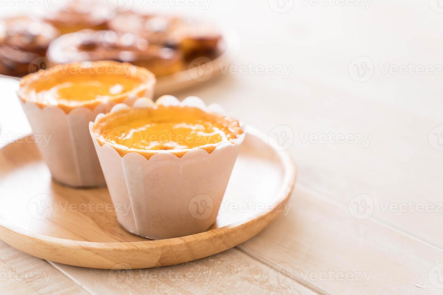 Egg tart on wood plate photo