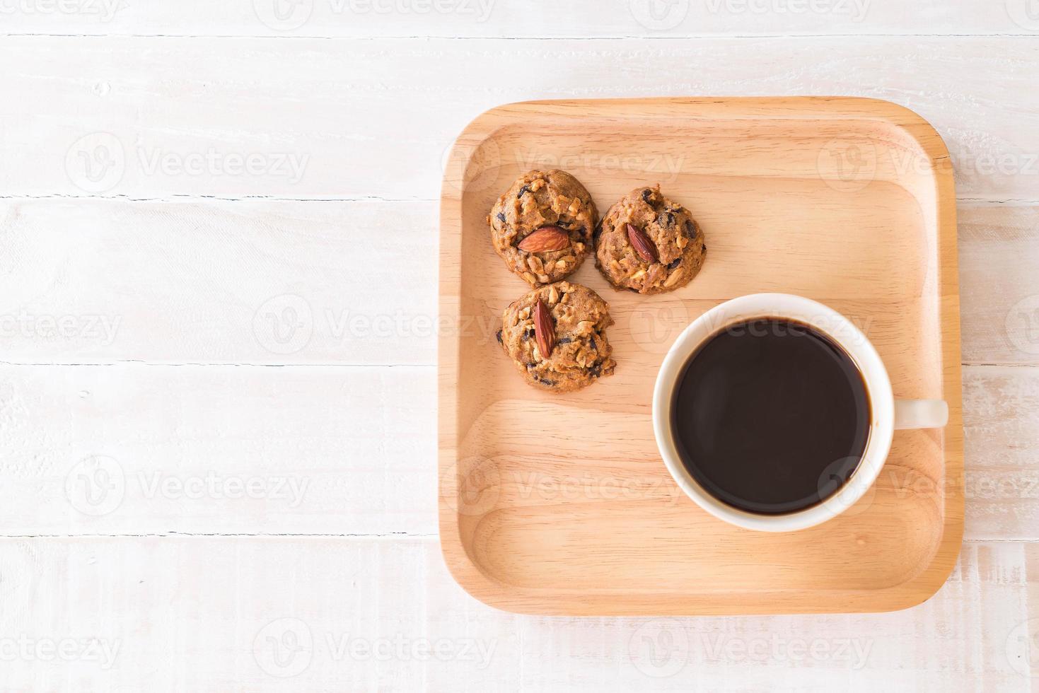 Black coffee with cookies on wood photo
