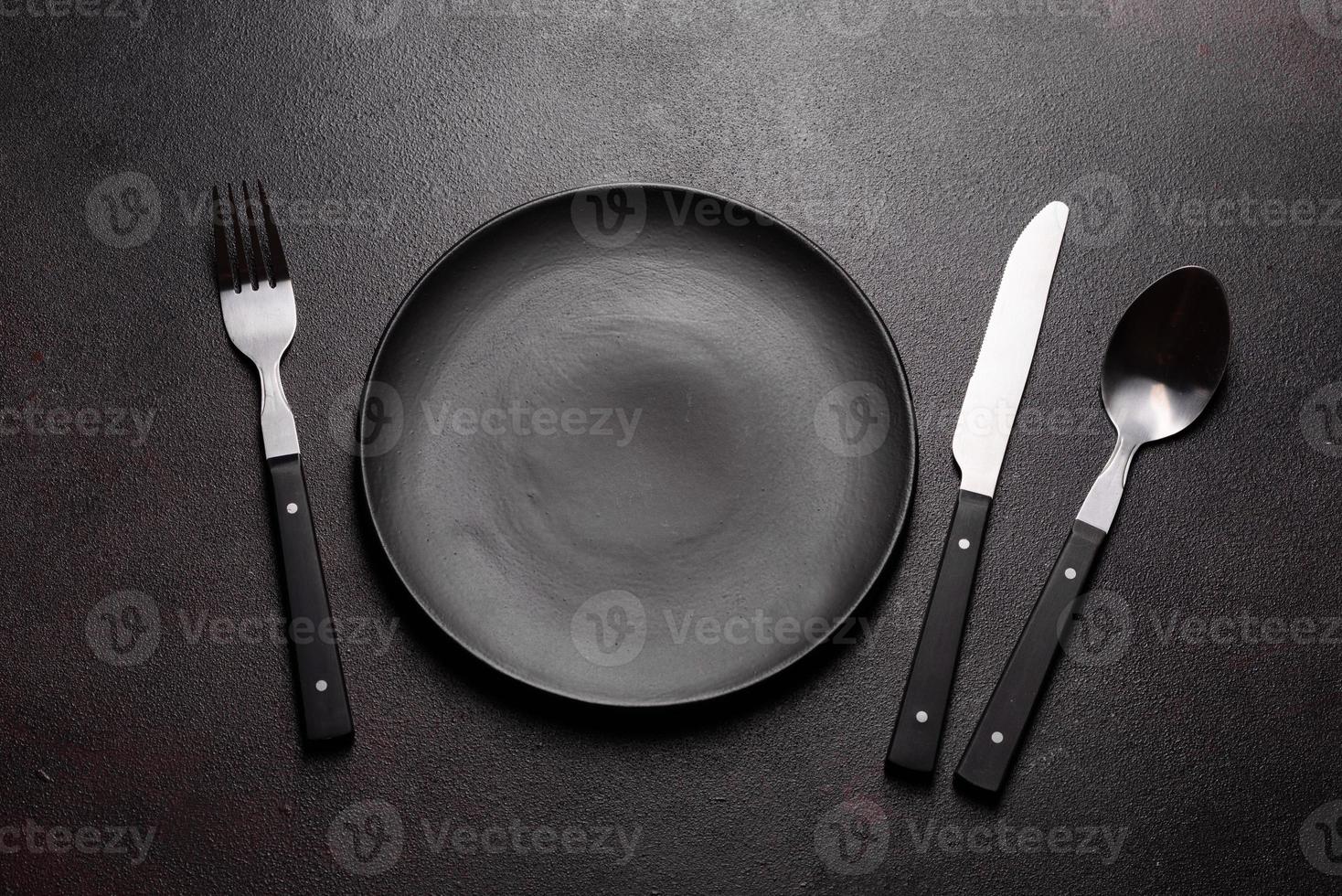 Set of tableware ready for the meal with black copy space photo