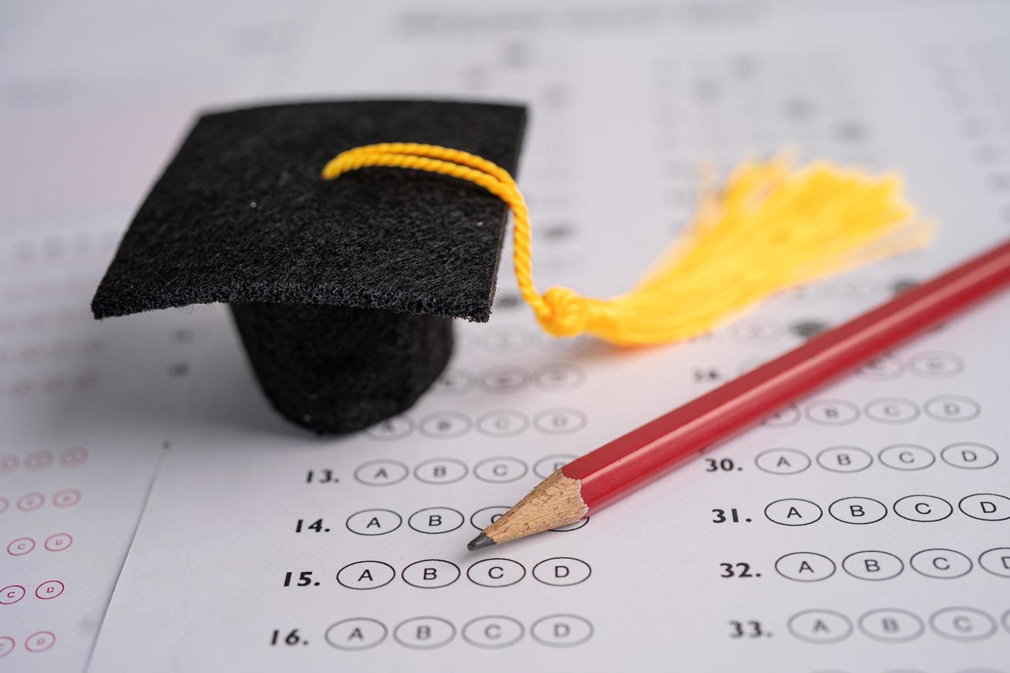 Graduation gap hat and pencil on answer sheet photo