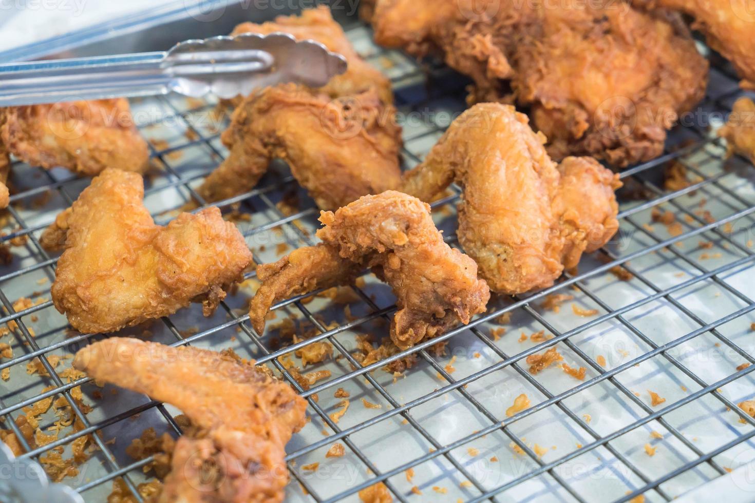 Deep-fried chicken on a steel grid photo