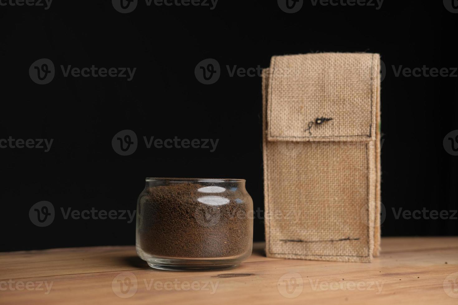 Loose tea in a glass jar and a organic bag on table . photo