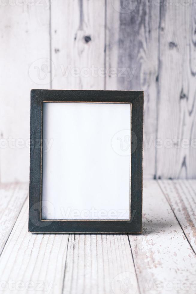 empty frame on wooden background . photo