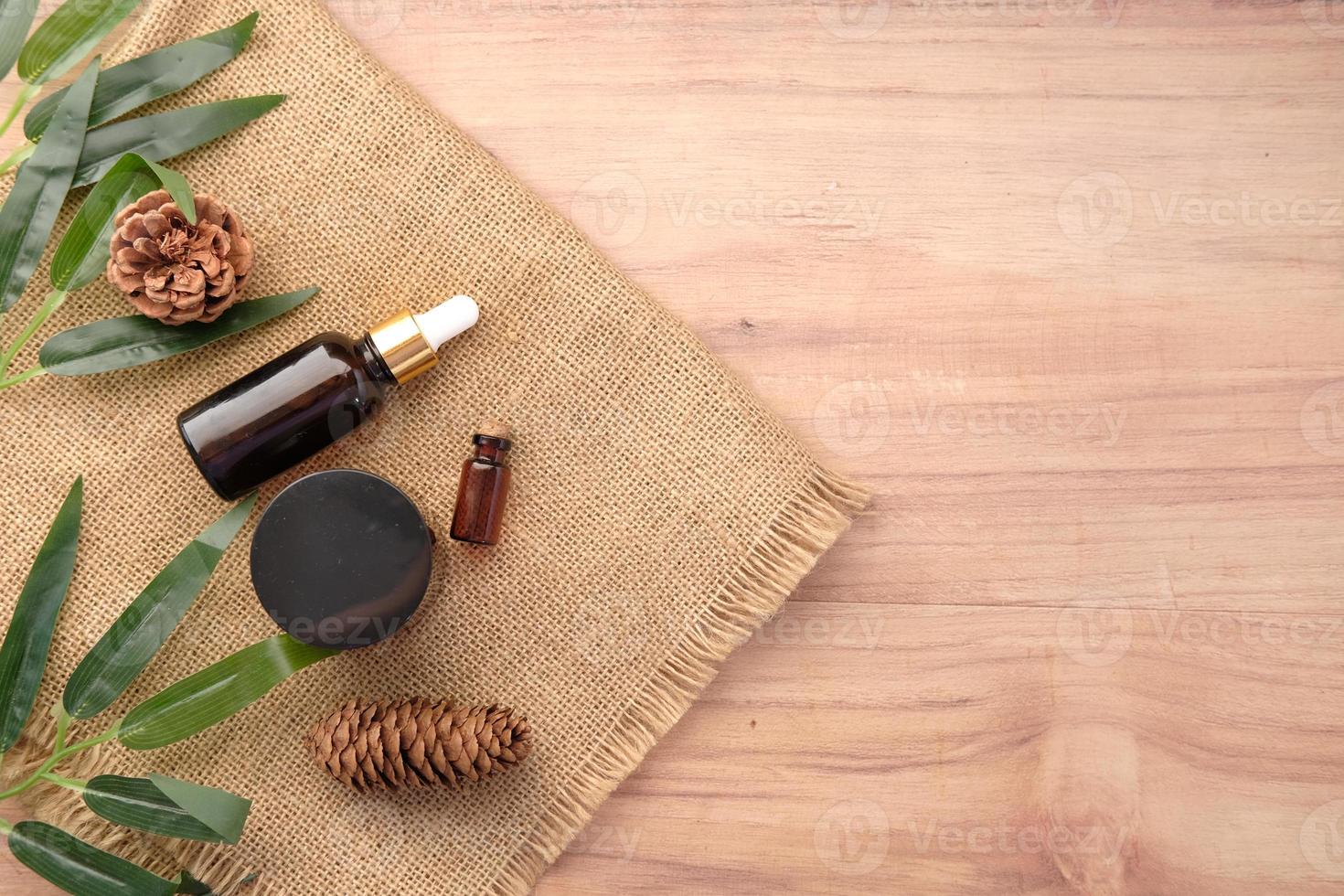 eucalyptus essential oils in a glass bottle with green leaf on table photo