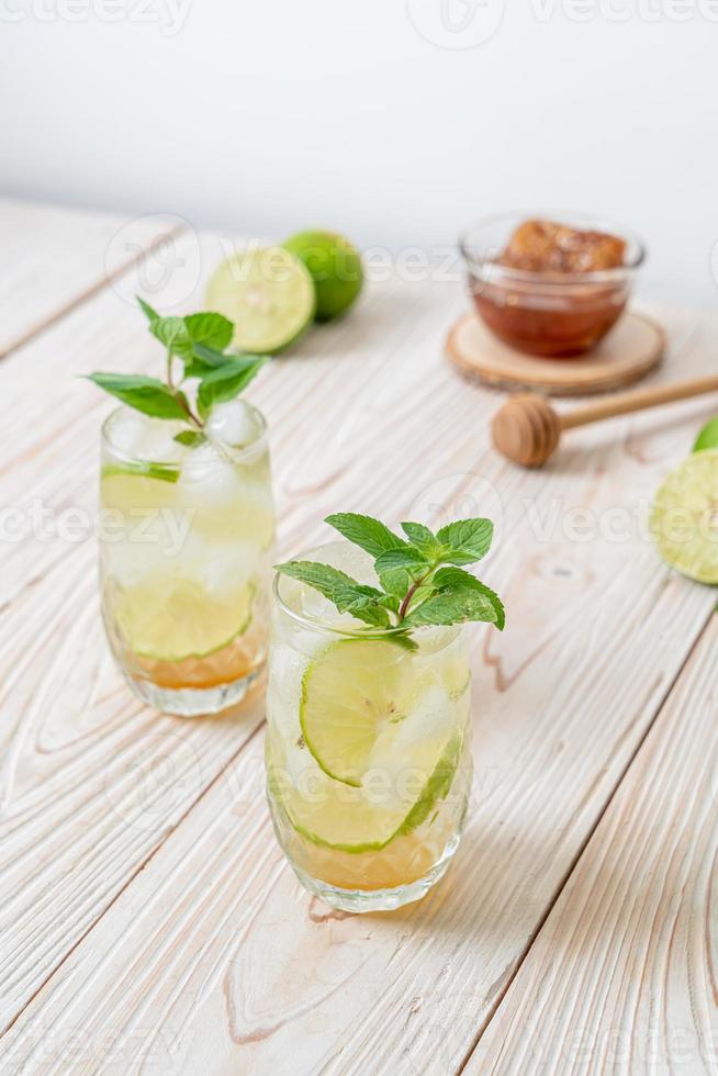 Iced honey and lime soda with mint - refreshing drink photo