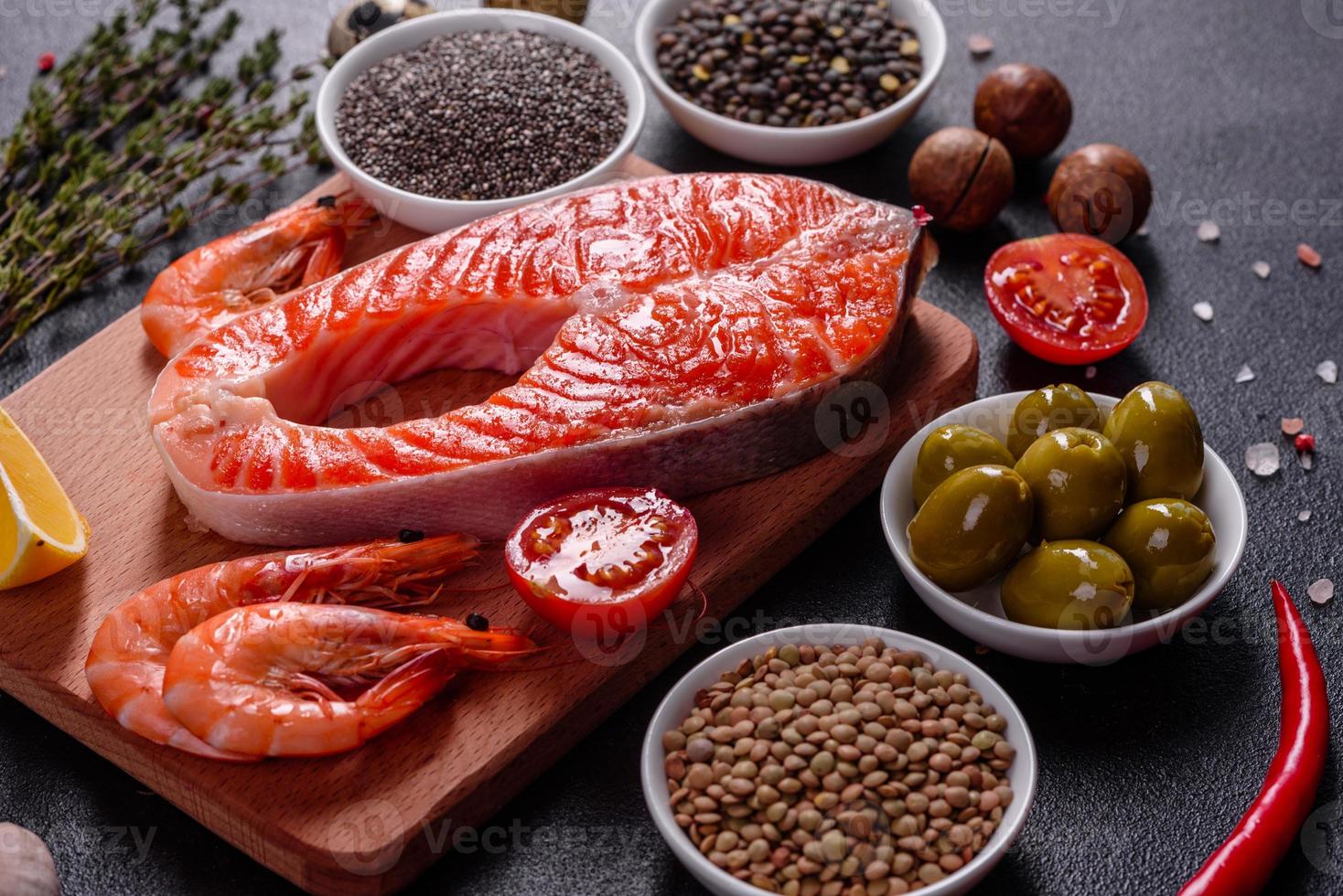 Raw trout red fish steak served with herbs and lemon photo