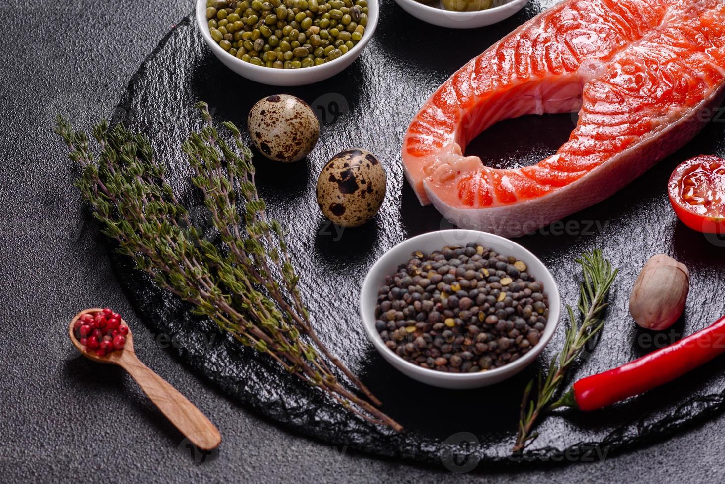 Raw trout red fish steak served with herbs and lemon photo