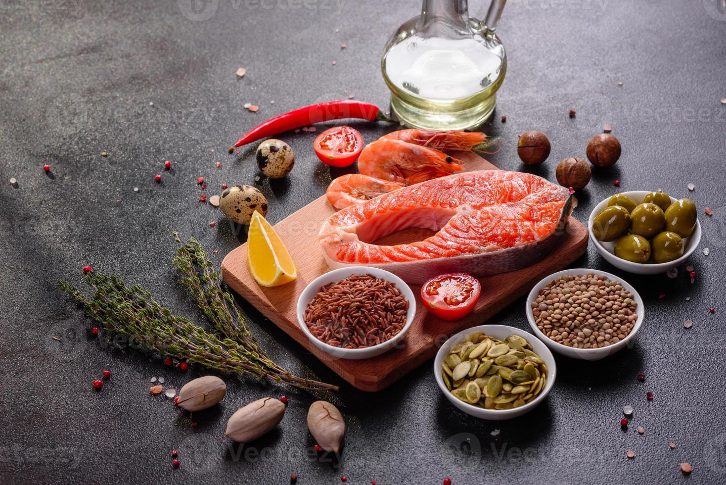 Raw trout red fish steak served with herbs and lemon photo