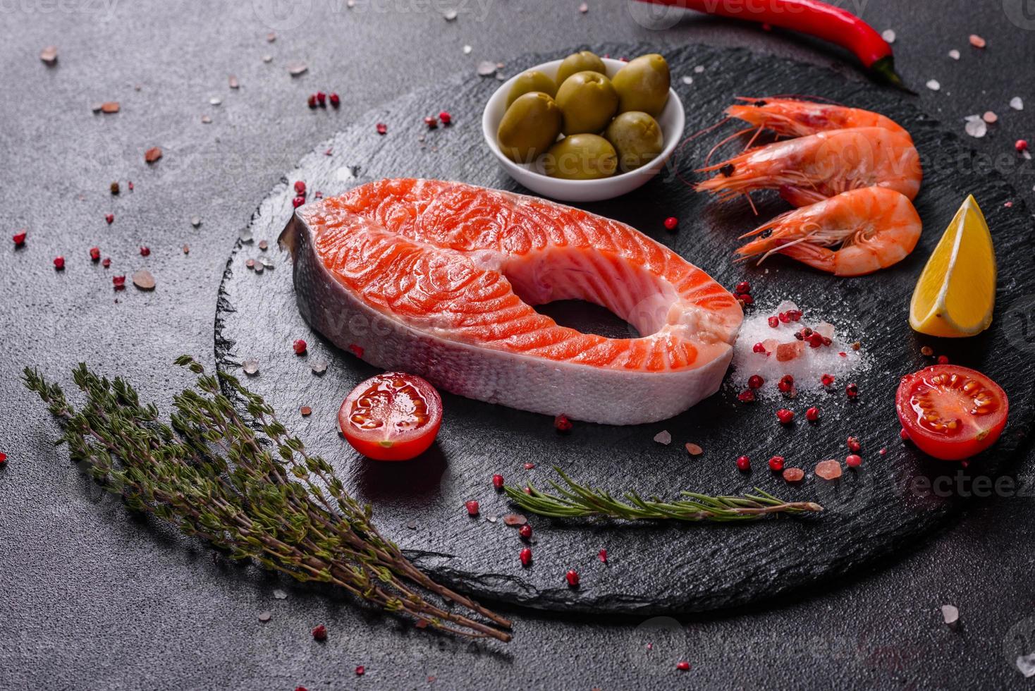 Raw trout red fish steak served with herbs and lemon photo