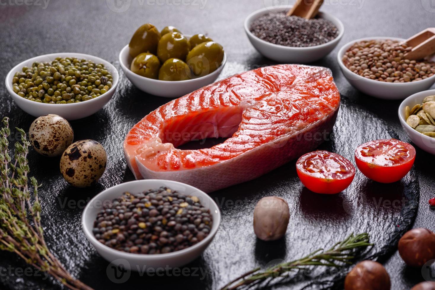 Raw trout red fish steak served with herbs and lemon photo