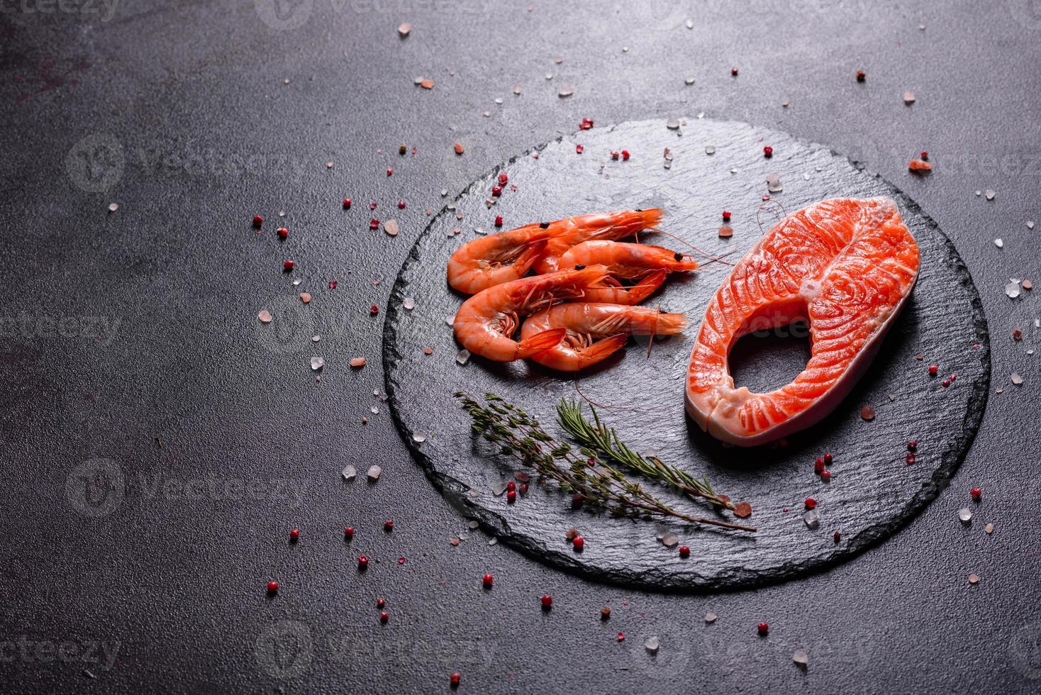 Raw trout red fish steak served with herbs and lemon photo