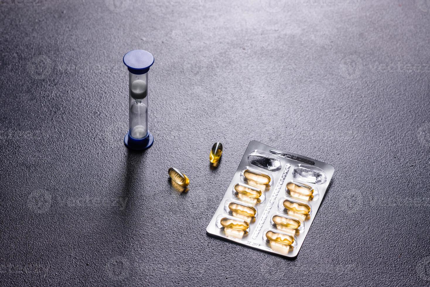 Omega 3 capsules on black dark background photo