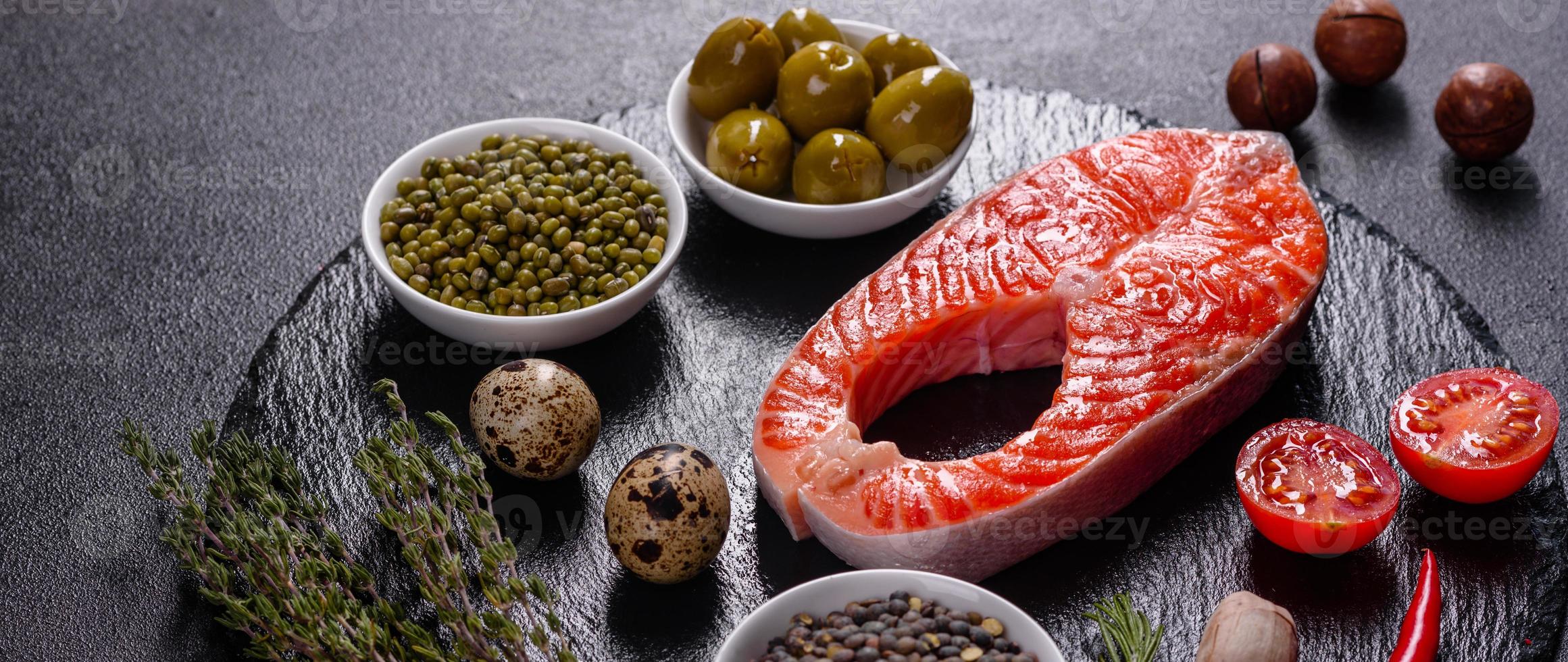 Raw trout red fish steak served with herbs and lemon photo