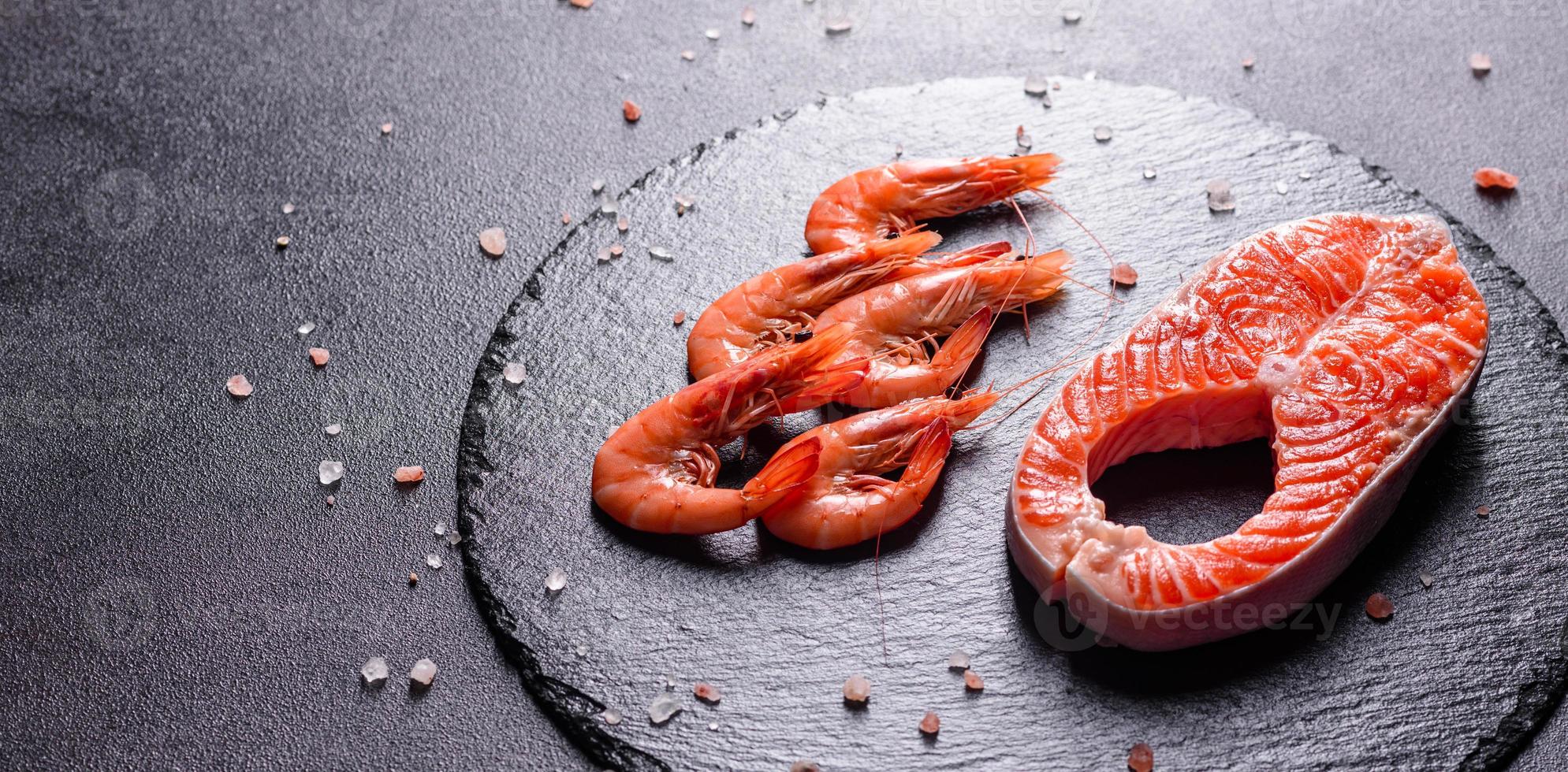 Raw trout red fish steak served with herbs and lemon photo