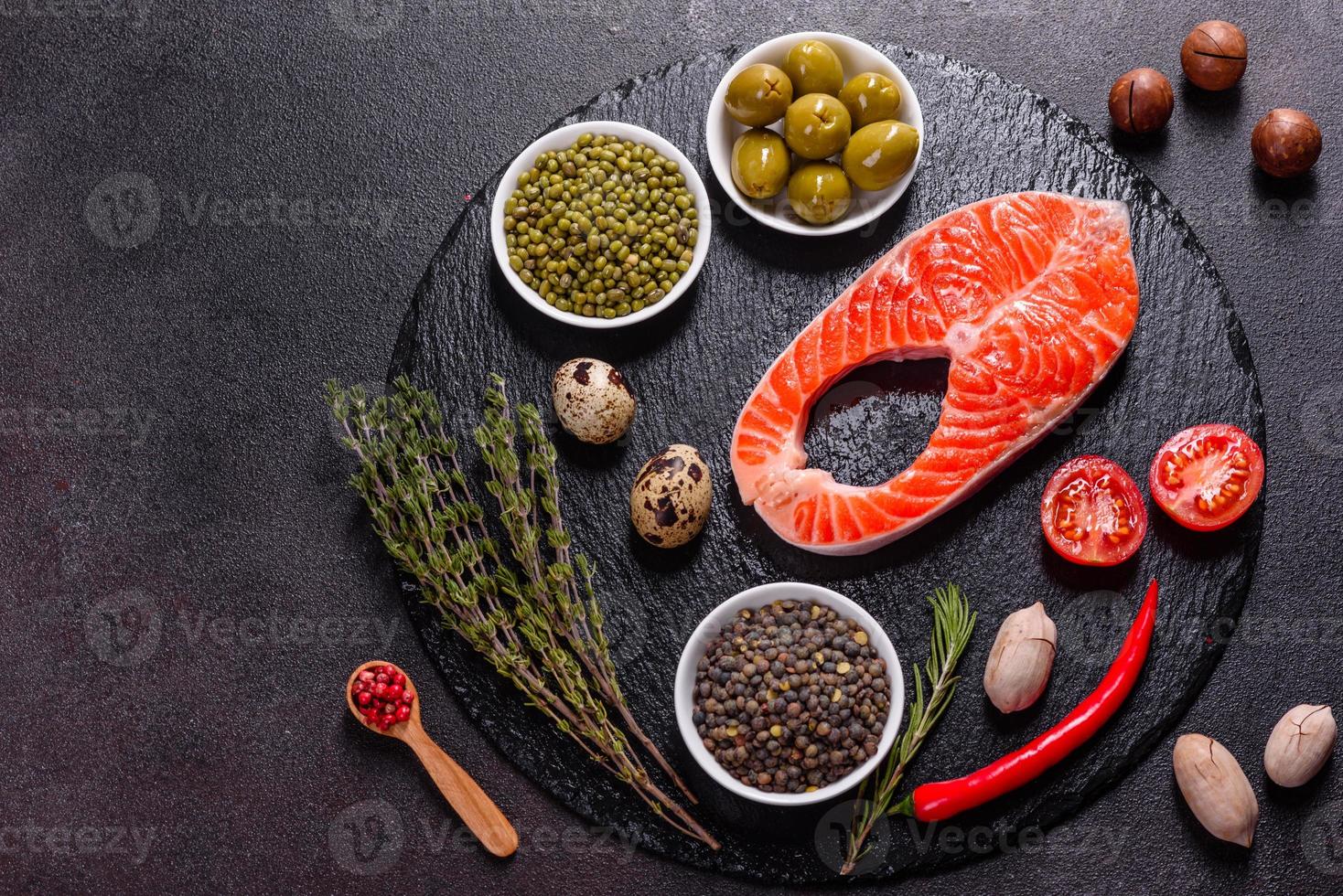 Raw trout red fish steak served with herbs and lemon photo
