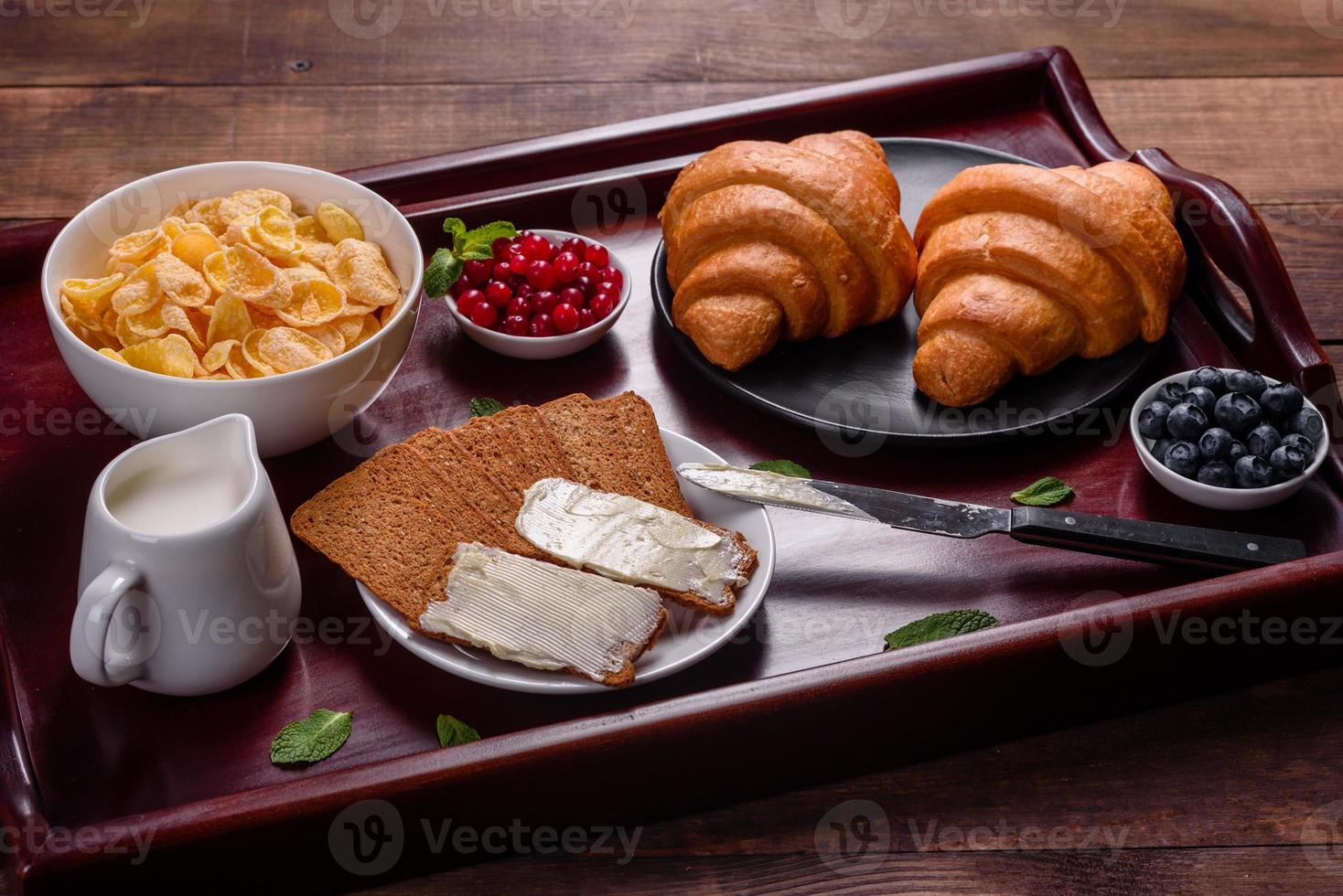 Delicious breakfast with fresh croissants and ripe berries photo