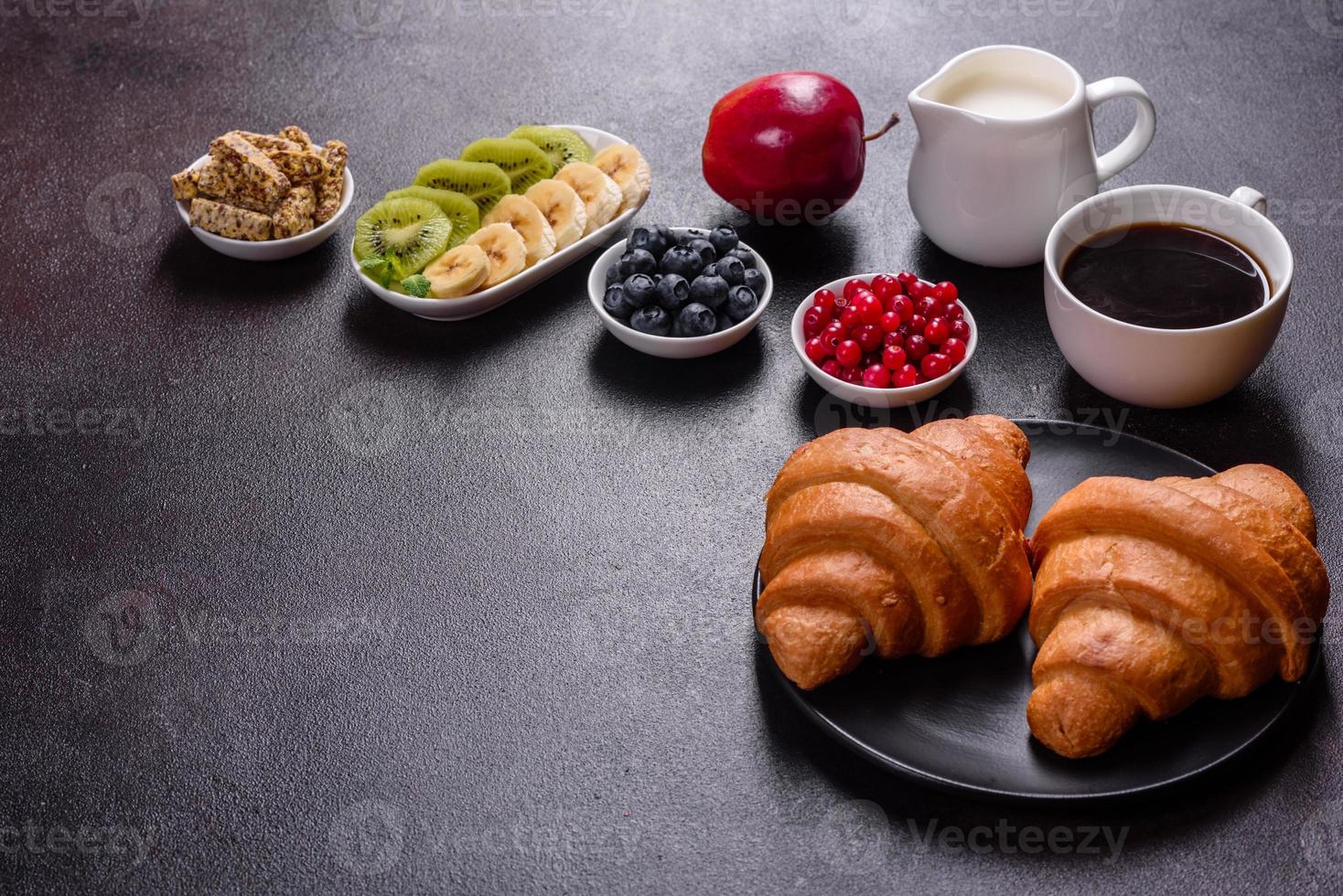 Delicious breakfast with fresh croissants and ripe berries photo