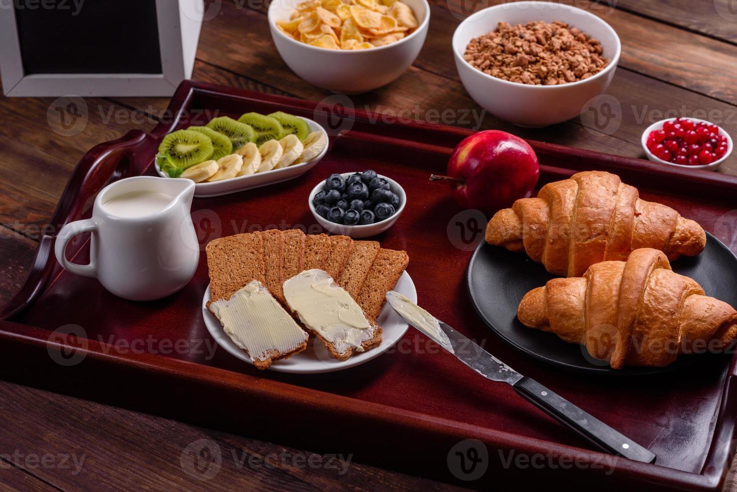 Delicious breakfast with fresh croissants and ripe berries photo