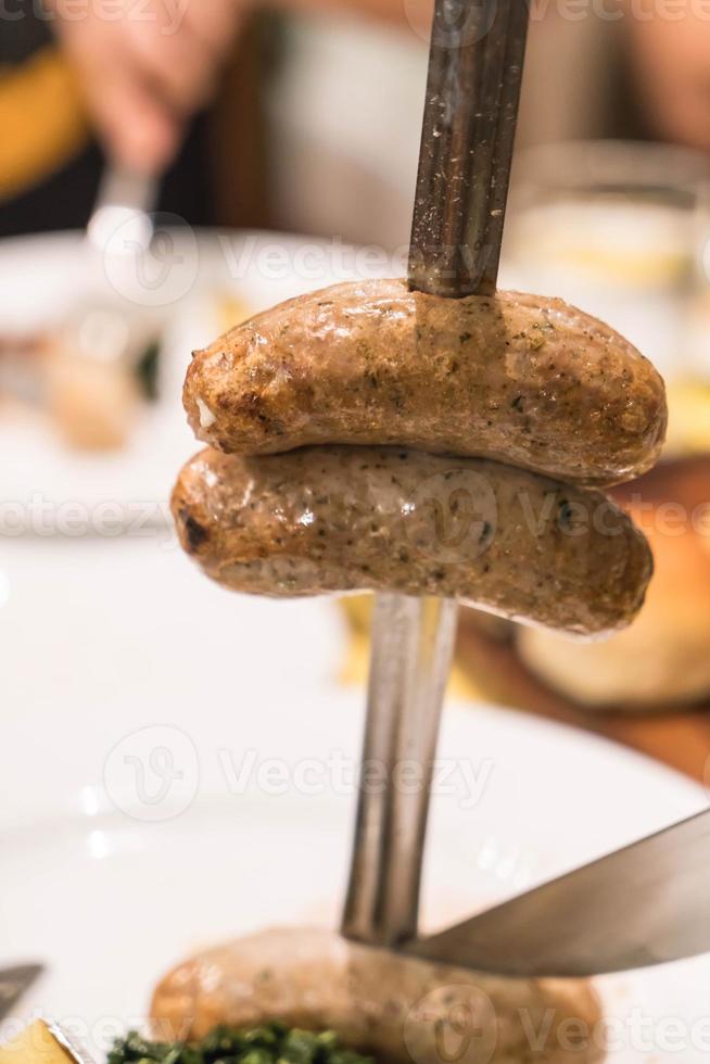 Slicing steak Brazillian style on plate photo