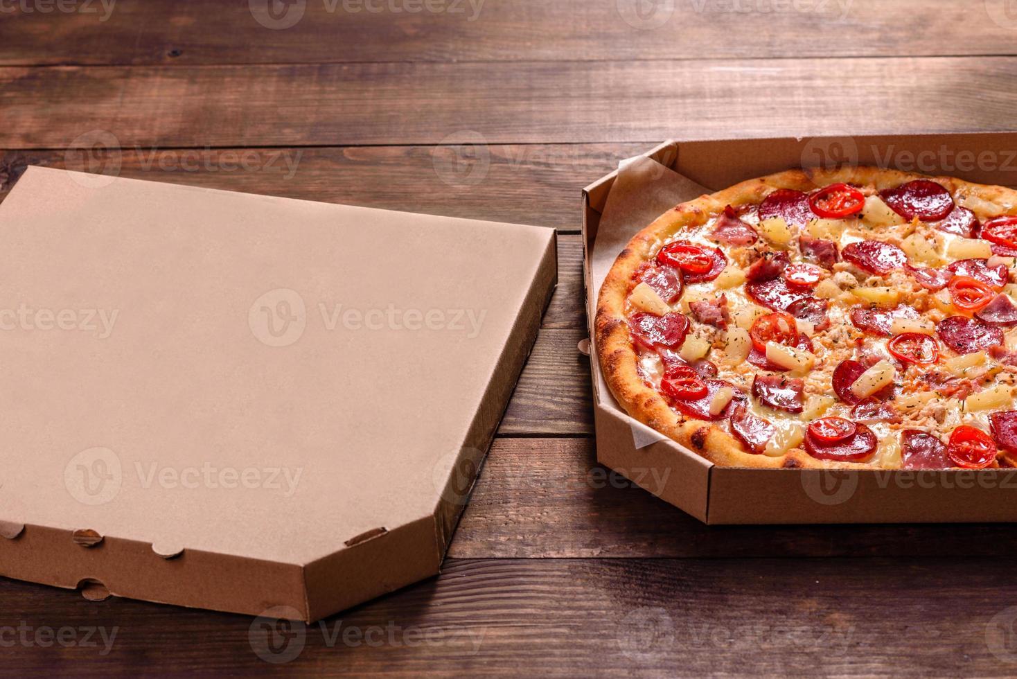Tasty sliced pizza with seafood and tomato on a concrete background photo