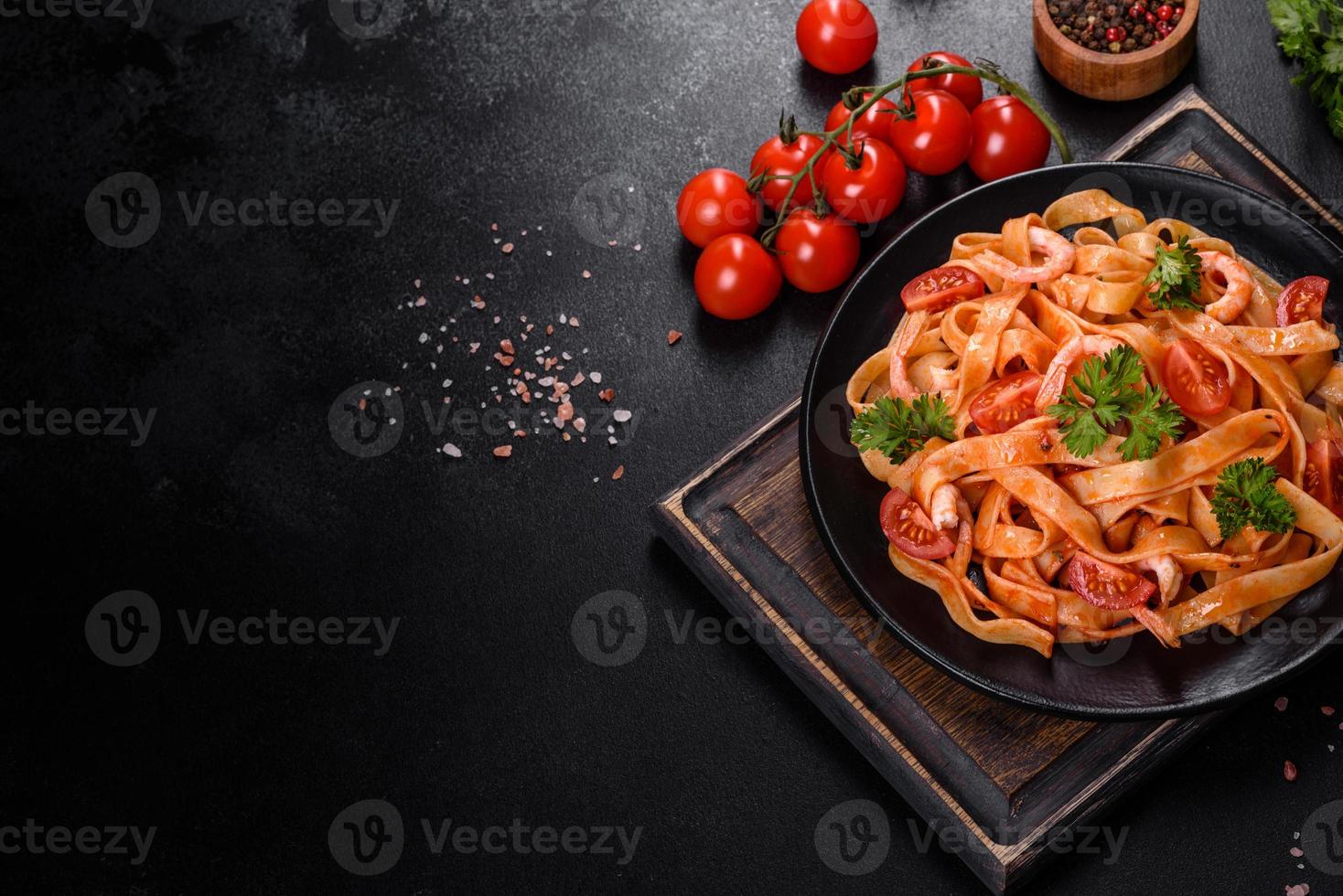 pasta fettuccine con camarones, tomates cherry, salsa, especias y hierbas foto