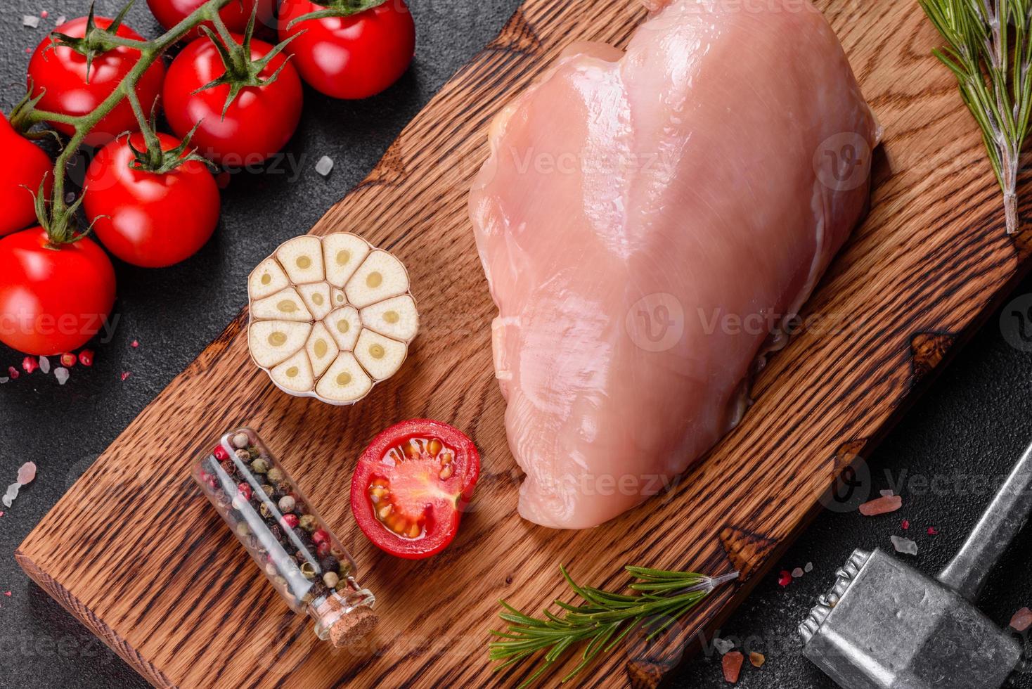 Fresh raw chicken fillet and vegetables prepared for cooking photo