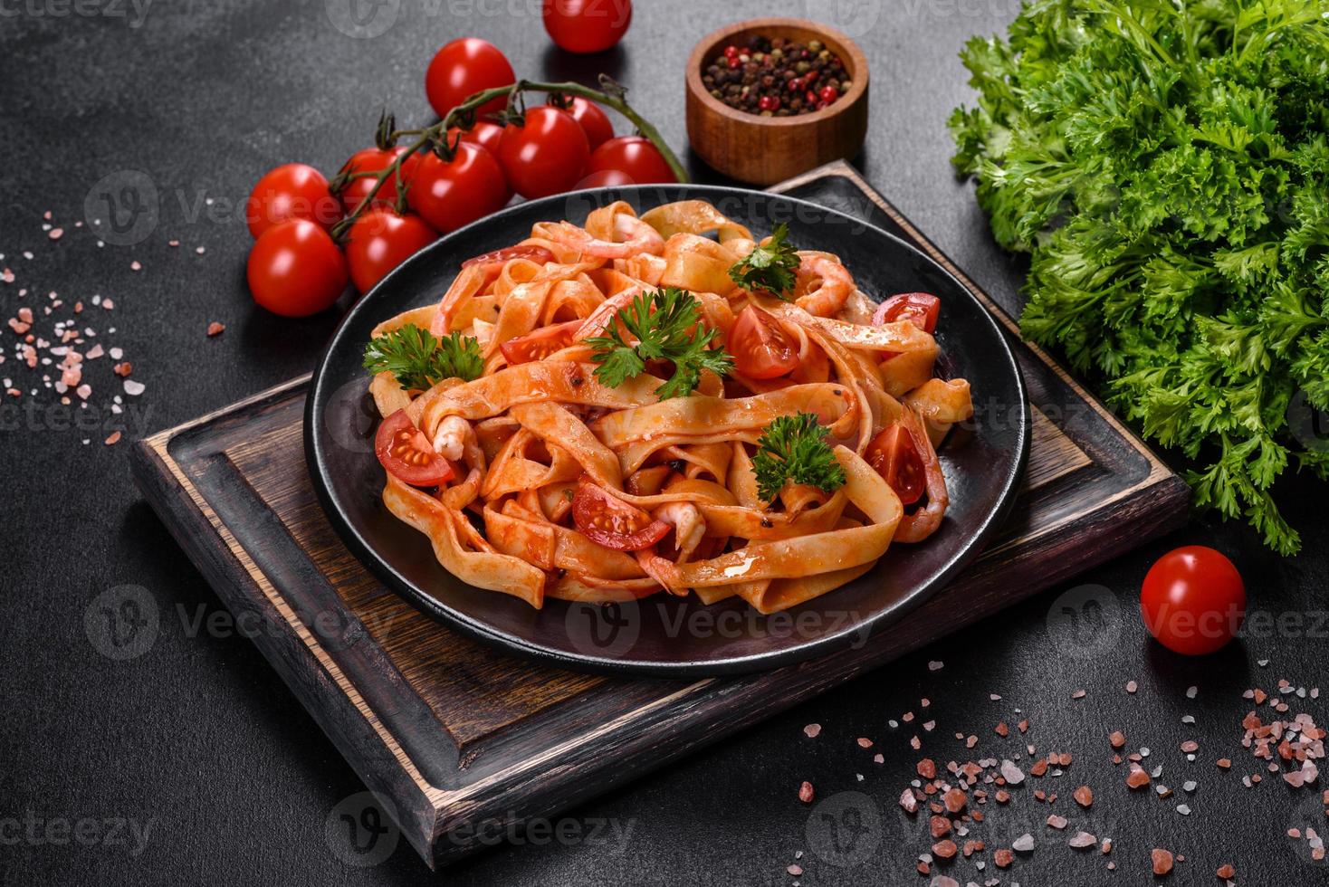 pasta fettuccine con camarones, tomates cherry, salsa, especias y hierbas foto