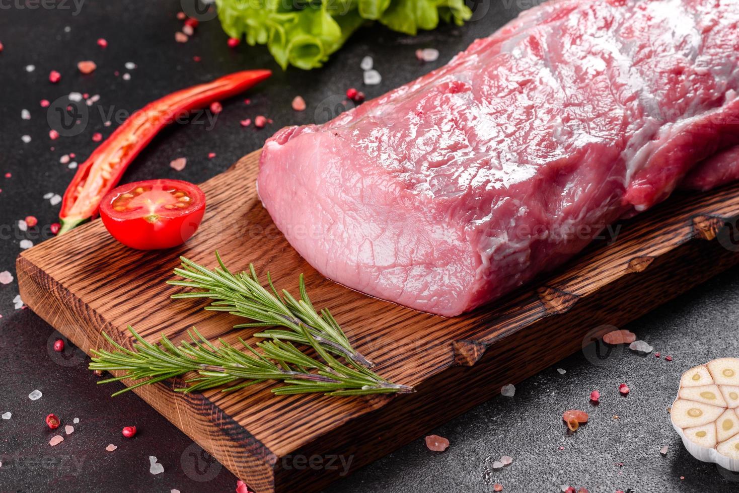 Fresh pieces pork ready to cook on a dark background photo