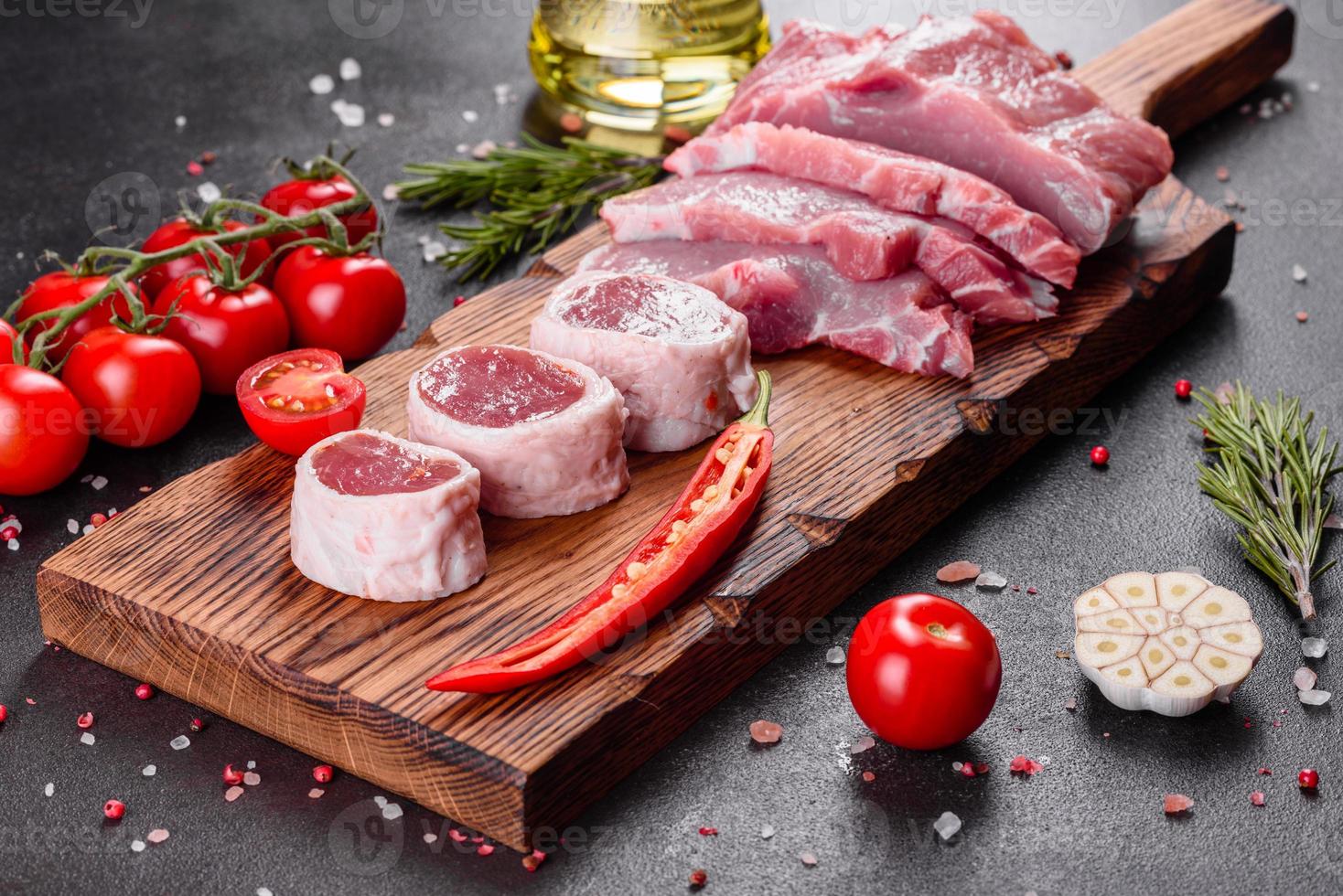 Fresh pieces pork ready to cook on a dark background photo